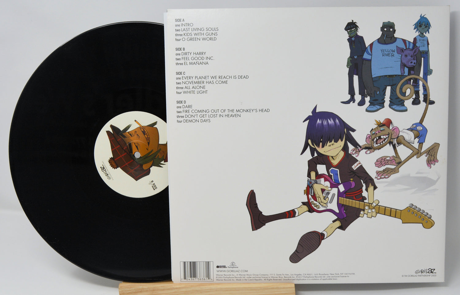 Vinyl record with a colorful album cover featuring an animated character and guitar.