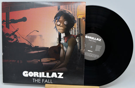 Vinyl record and cover for Gorillaz' 'The Fall' on a light gray background