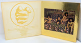 Album cover with a yellow and gold design featuring a bee logo and a photo of people sitting on grass.