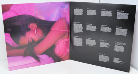 Album cover with a pink and black design featuring text on a white background