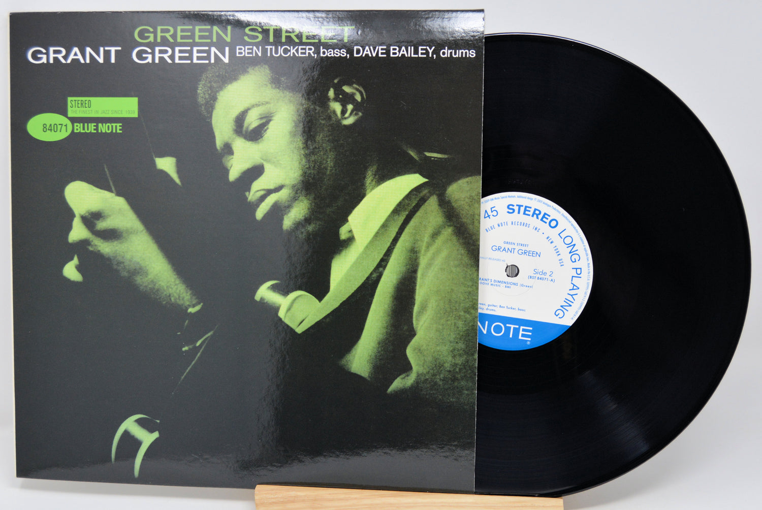 Grant Green 'Green Street' vinyl record LP with the album cover standing next to the black record on a small wooden stand against a light gray background.