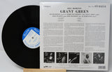Back cover and vinyl record of Grant Green's Idle Moments Blue Note LP with tracklist and liner notes