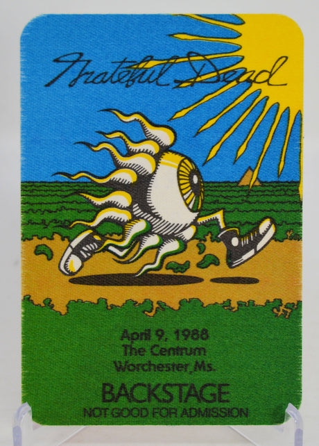 Backstage pass with 'The Grateful Dead' logo and event details on a blue, yellow, and green background.