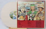 Vinyl record with a colorful cover featuring illustrations of people and objects.
