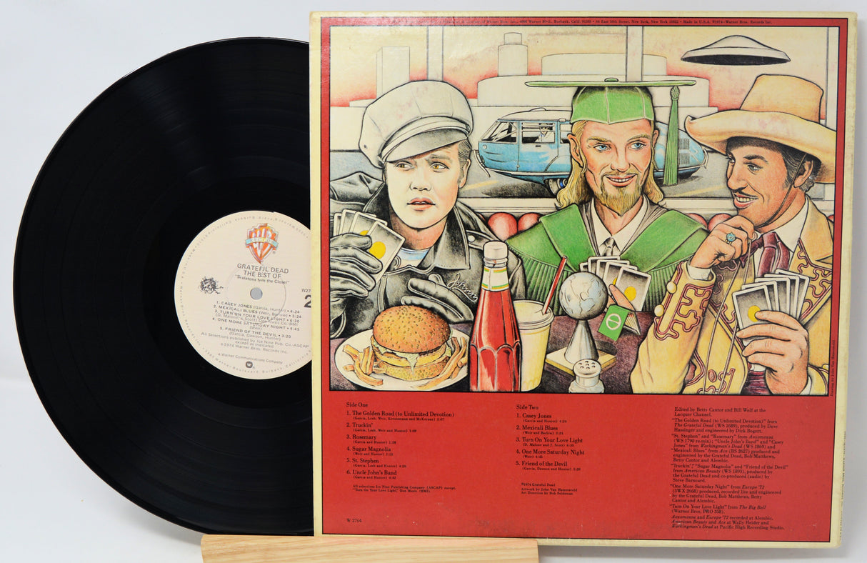 Vinyl record with a colorful cover featuring three people and a burger, on a light gray background.