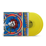 A clear yellow vinyl record of Grateful Dead - Skull & Roses with a colorful album cover featuring a skull with flowers and the Grateful Dead logo.