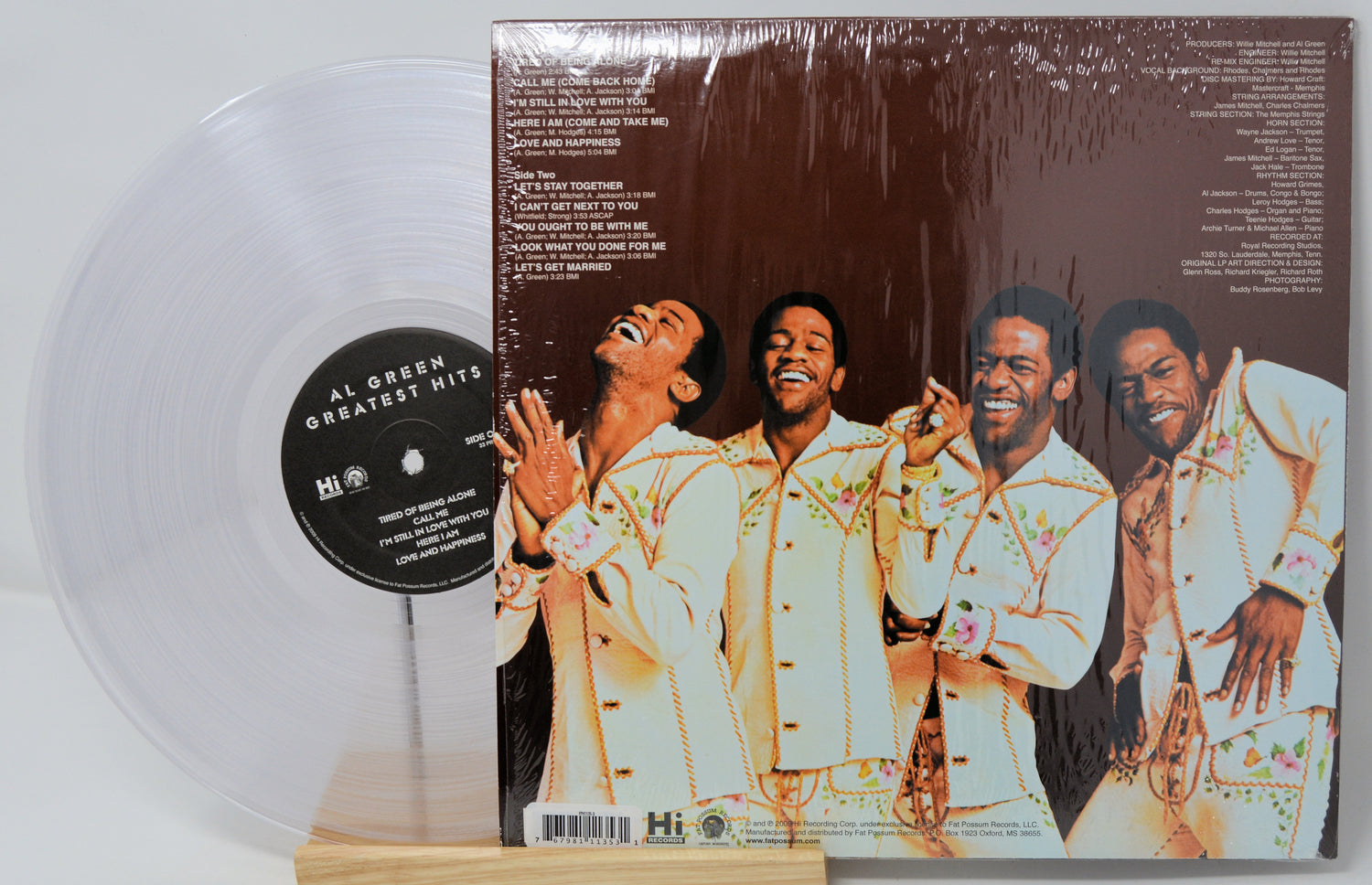 Vinyl record with a cover featuring four men and a clear vinyl disc.