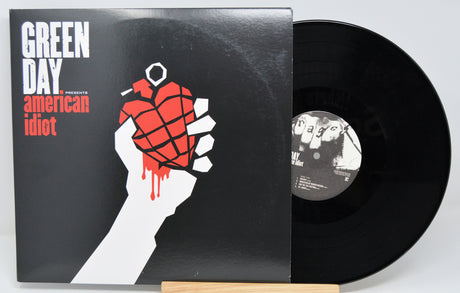 Vinyl record with 'Green Day' album cover featuring a hand holding a red grenade.