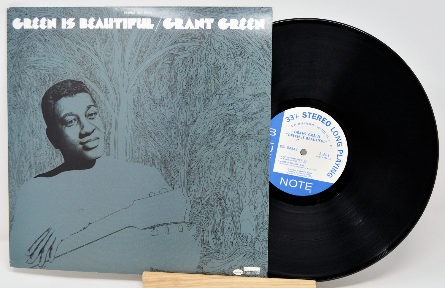 Vinyl record and cover with 'Green is Beautiful' by Grant Green on a white background