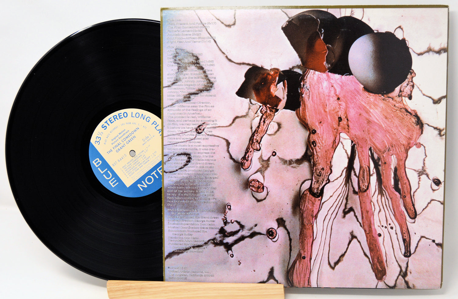 Vinyl record with a colorful album cover featuring abstract art.