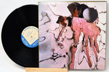 Vinyl record with a colorful album cover featuring abstract art.