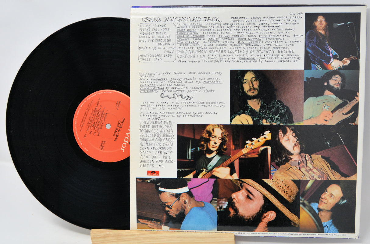 Vinyl record with a colorful cover featuring images of a band and text.