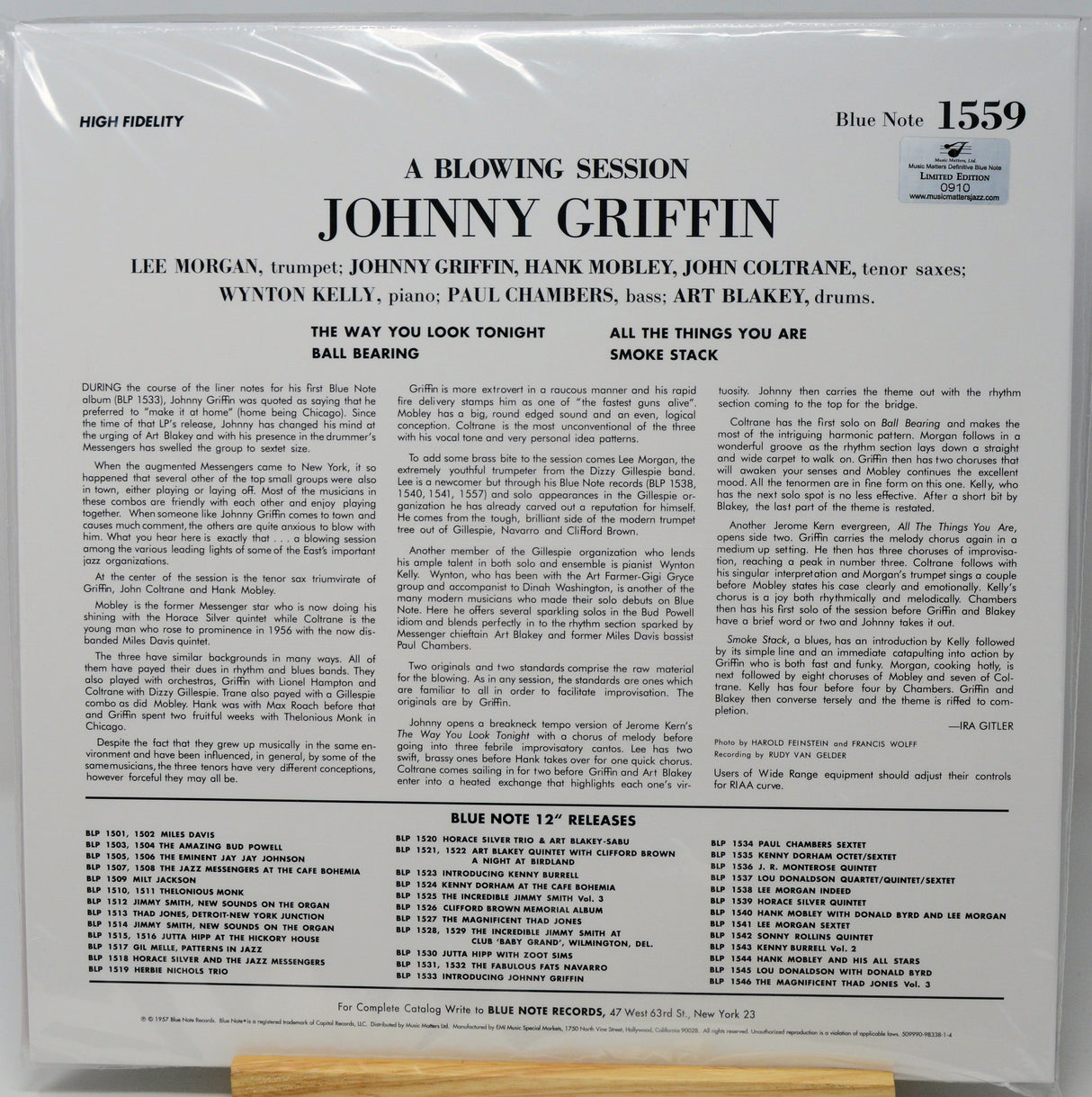 Back cover of a vinyl record sleeve for 'A Blowing Session: Johnny Griffin' on Blue Note, photographed flat against a white background with a small wooden stand visible at the bottom.