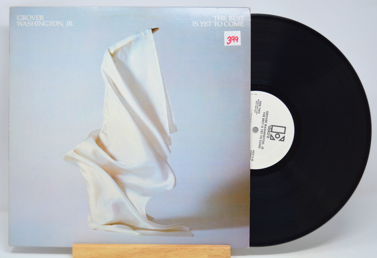 'Grover Washington Jr - The Best Is Yet To Come' Vinyl record with a white cover featuring a draped fabric design on a light gray background.