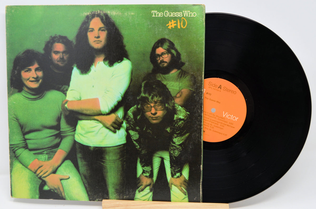 Vinyl record with cover featuring a band and green album design