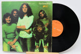 Vinyl record with cover featuring a band and green album design