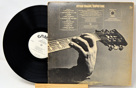 Back cover and vinyl record of Attila Zoller's Gypsy Cry LP with close-up guitar hand image
