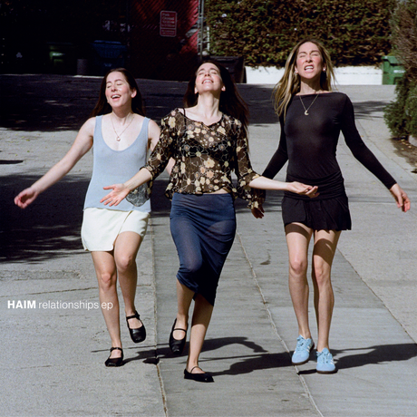 Three women walking together on a sidewalk with 'HAIM relationships ep' text overlay.
