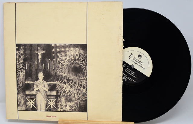 Vinyl record with cover featuring a black and white illustration of a person in a room.