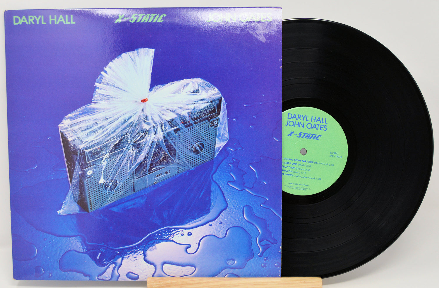 Vinyl record with a blue front cover featuring a boom box and 'Daryl Hall & John Oates'  X-Static text.