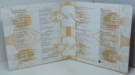 An open three-panel booklet or program spread, photographed from above on a light surface. The pages are predominantly white with beige/tan abstract line art and small circular photographic inserts, plus dense black text.