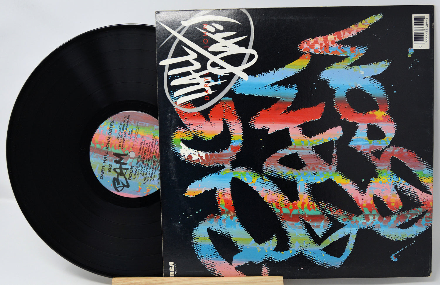 Vinyl record with a colorful cover featuring abstract designs and a visible label.