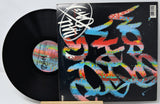 Vinyl record with a colorful cover featuring abstract designs and a visible label.