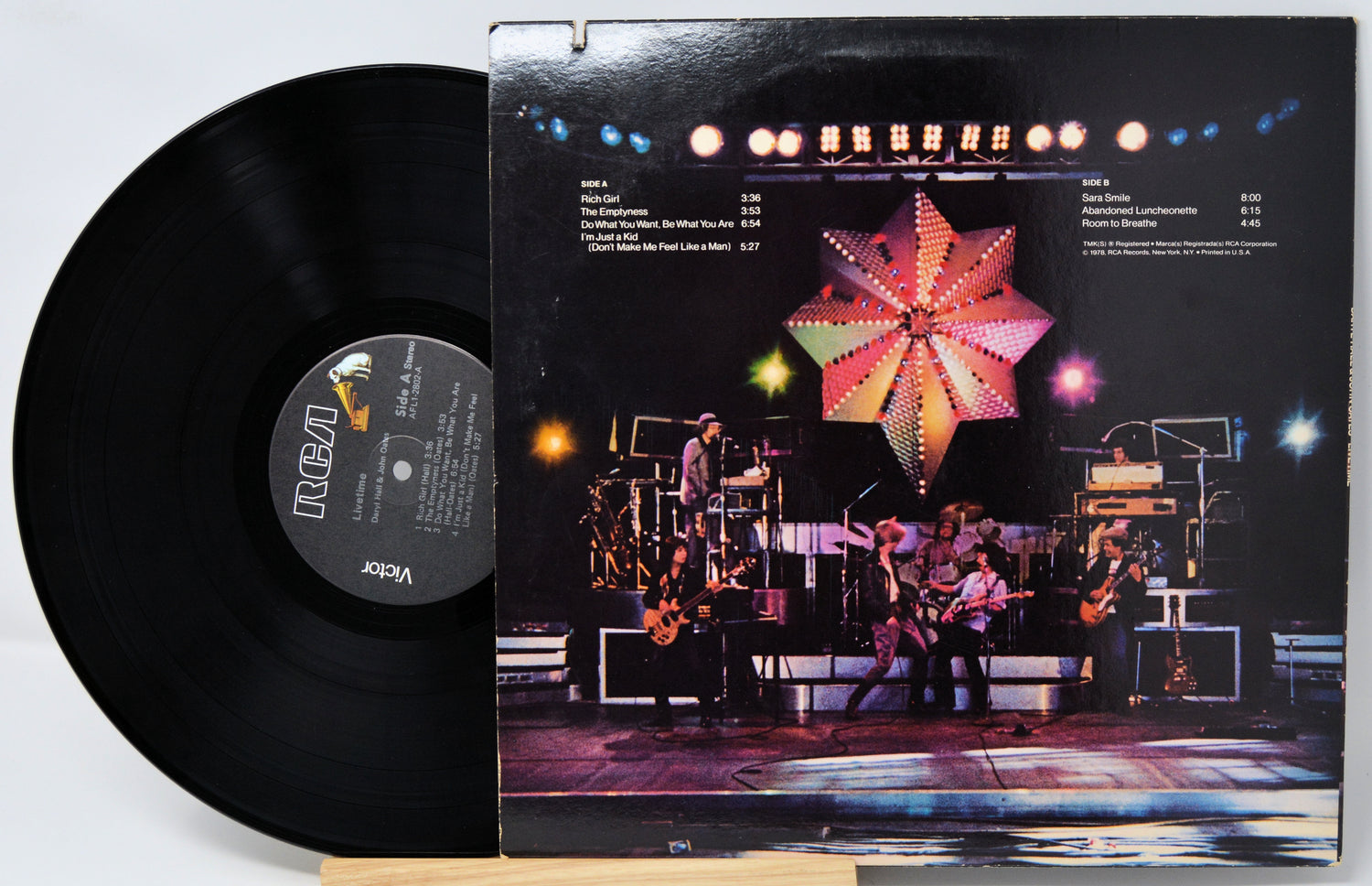 Vinyl record with a colorful album cover featuring a band on stage.