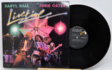 Vinyl record and cover featuring Daryl Hall and John Oates with a concert scene on the cover.