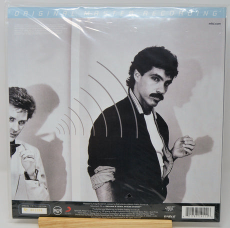 Vinyl record album cover for 'Original Hip-Hop Recording' featuring a black-and-white photo of a man with a mustache, sealed in plastic shrink wrap, displayed on a wooden stand.