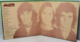 An open vinyl record sleeve or booklet showing three sepia-toned portraits of Frank Sinatra on the right page and a tracklist on the left page, photographed against a light neutral background.
