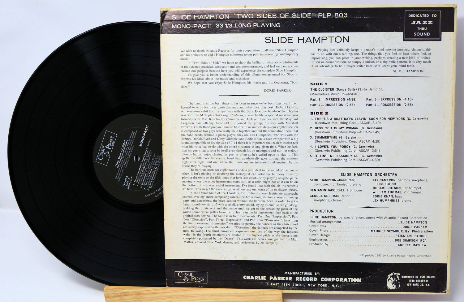 Vinyl record with a colorful cover featuring a person playing a trombone, on a white background.