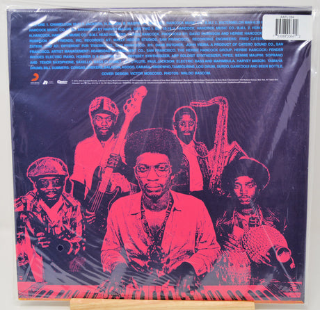 Vinyl record album cover for 'The Godfather Jazz Collection' on a wooden display stand, wrapped in protective plastic with a barcode sticker in the top right corner.