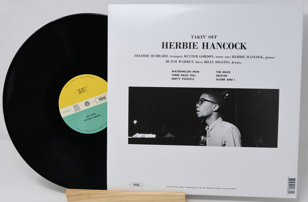 Vinyl record and cover with 'Takin' Off' by Herbie Hancock on a white background