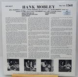 Back cover of a Hank Mobley music record sleeve, printed in black text and three small black-and-white photos on an off-white background, with the Blue Note logo and catalog number 1568 visible.