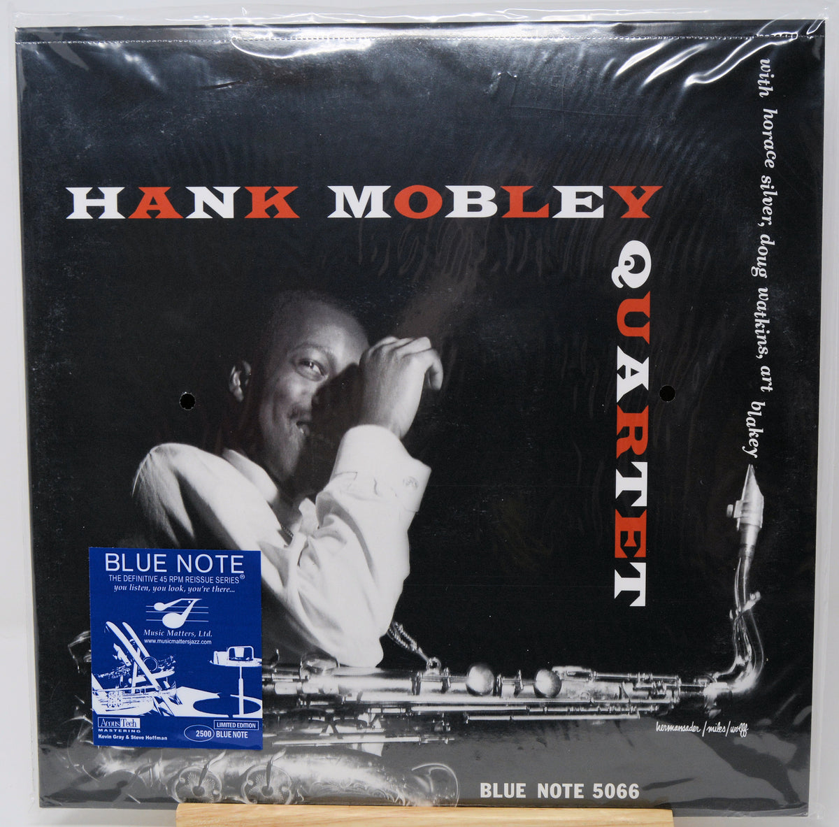 Hank Mobley Quartet vinyl record cover on a black background, sealed in plastic shrink wrap with a Blue Note sticker visible on the lower left. The cover features a black-and-white photo of Hank Mobley with red and white text reading 'HANK MOBLEY QUARTET'.