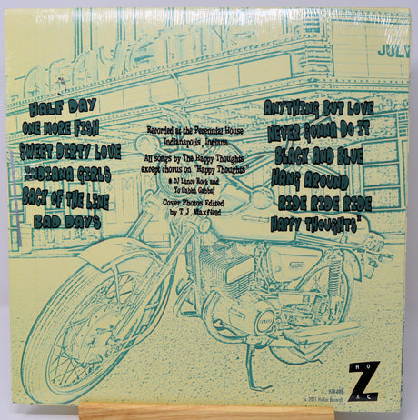 Album cover with motorcycle illustration and text on a yellowed paper background
