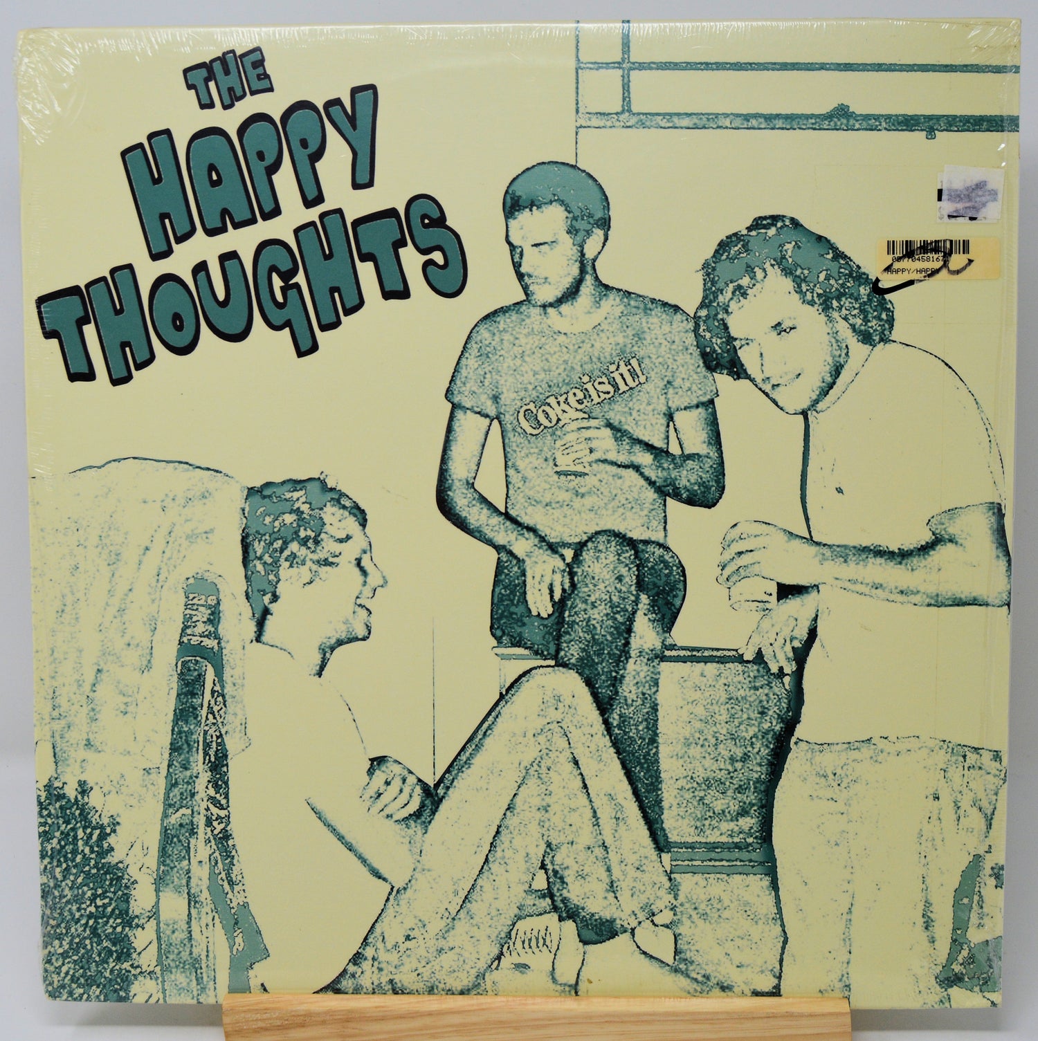 Album cover with illustration of three people and text 'The Happy Thoughts' on a beige background
