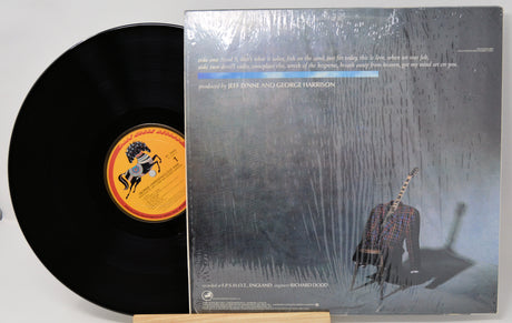 Vinyl record with cover featuring a person playing guitar on a textured background