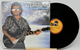 Vinyl record with a cover featuring a person holding a guitar, titled 'Cloud Nine'.