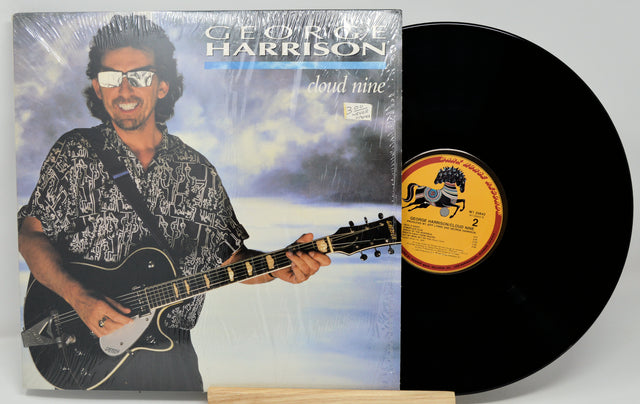 Vinyl record with a cover featuring a person holding a guitar, titled 'Cloud Nine'.