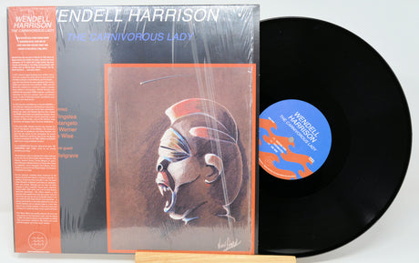Vinyl record and cover with 'Endell Harrison' and 'The Carnivorous Lady' text on a white background