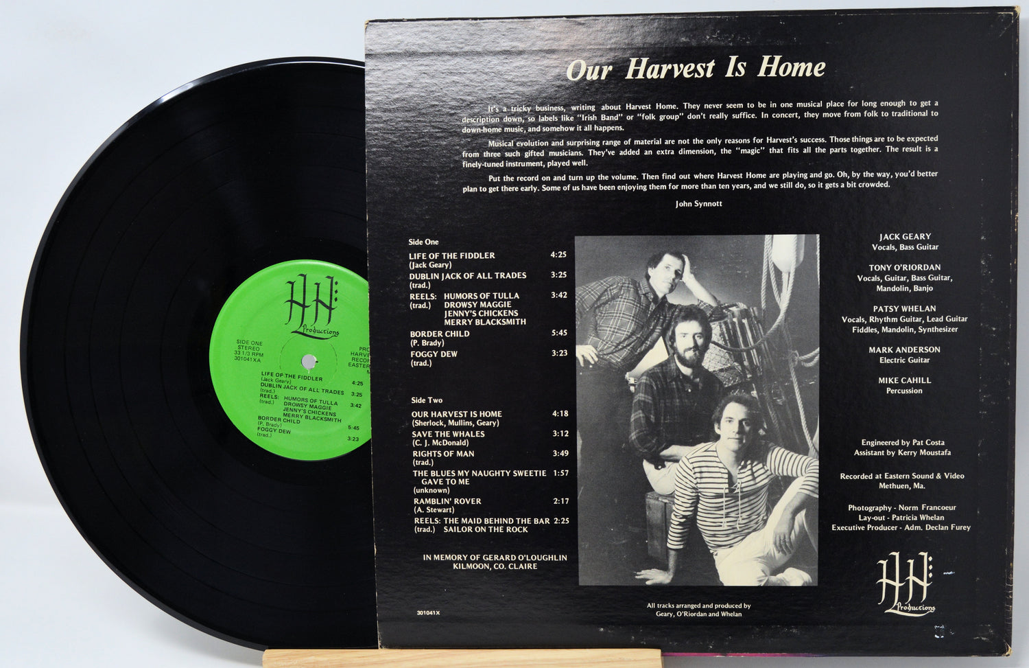Vinyl record with green label and black cover featuring text and a photo of two people.