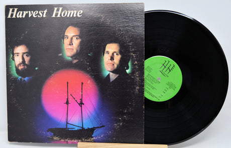 Vinyl record and cover titled 'Harvest Home' with a ship illustration on a dark background.
