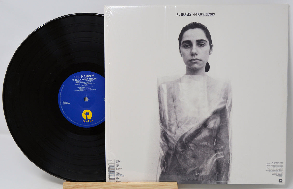 Vinyl record and its cover featuring a black and white portrait on a light gray background