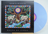 Front cover of Khruangbin's Hasta El Cielo blue vinyl with colorful tree, cows, and psychedelic eye artwork