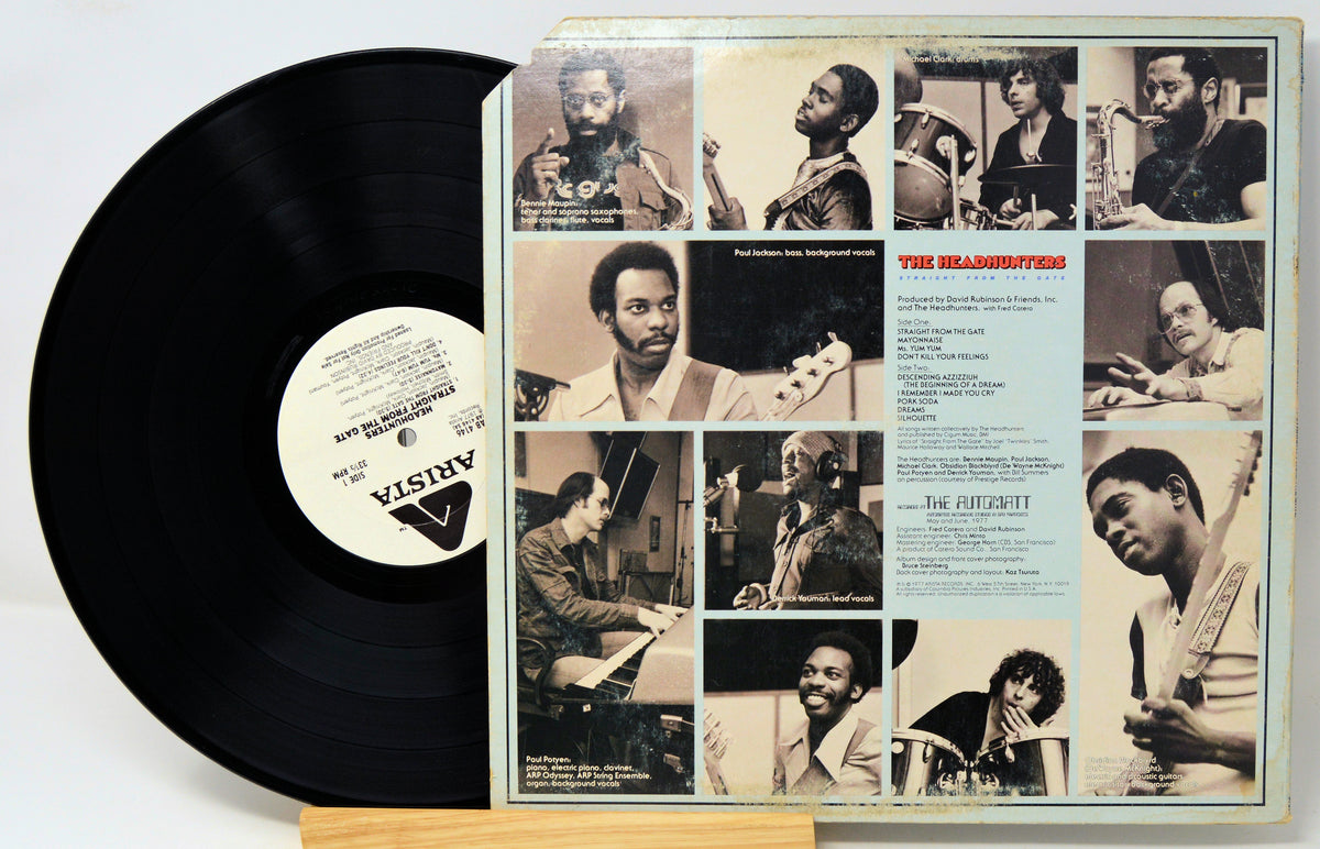 A vinyl record partially pulled from its sleeve, showing the black record on the left and the printed album cover on the right. The cover features multiple sepia-toned photographs of a man playing instruments, with the title 'The Melodists' and artist text visible.