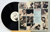 A vinyl record partially pulled from its sleeve, showing the black record on the left and the printed album cover on the right. The cover features multiple sepia-toned photographs of a man playing instruments, with the title 'The Melodists' and artist text visible.