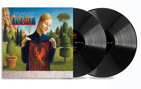 Heart - Greatest Hits A vinyl record album titled 'Heart - Greatest Hits' featuring a graphical cover art with a woman holding a guitar.