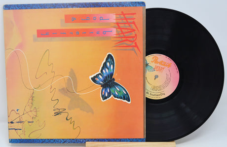 Vinyl record with a colorful cover featuring a butterfly design on a white background